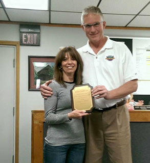 man present plaque to woman