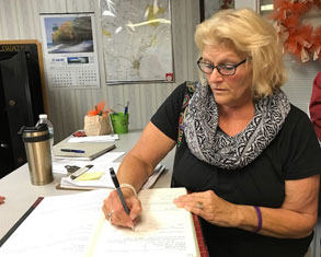woman signs book