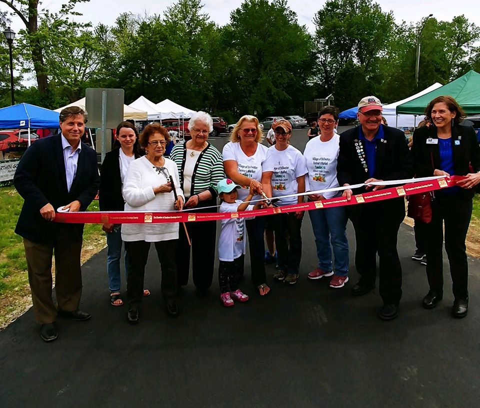 group of people cutting a ribbon