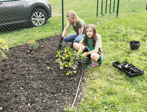 girls planting flowers