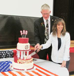 man and woman cut a cake