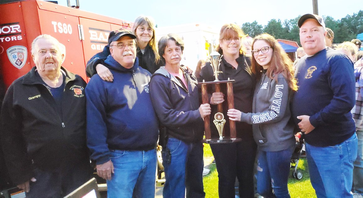 group of firefighters with a trophy