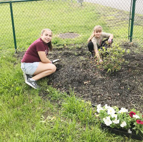 girls planting flowers