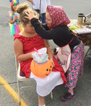 girl paints another girls face
