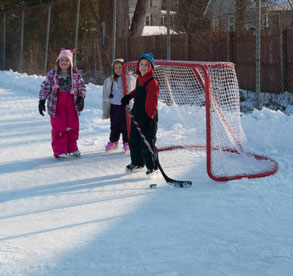 children play hockey on ice rink