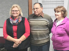 man and two woman in a group