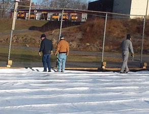 men prepare the ice skating rink