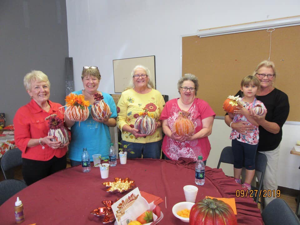 group of ladies showing off their pumpkins
