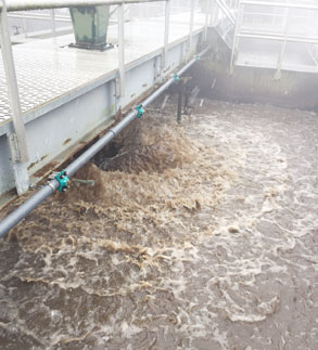 water flows into a tank at sewer plant