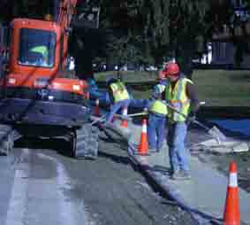 crews work on sidewalk repairs