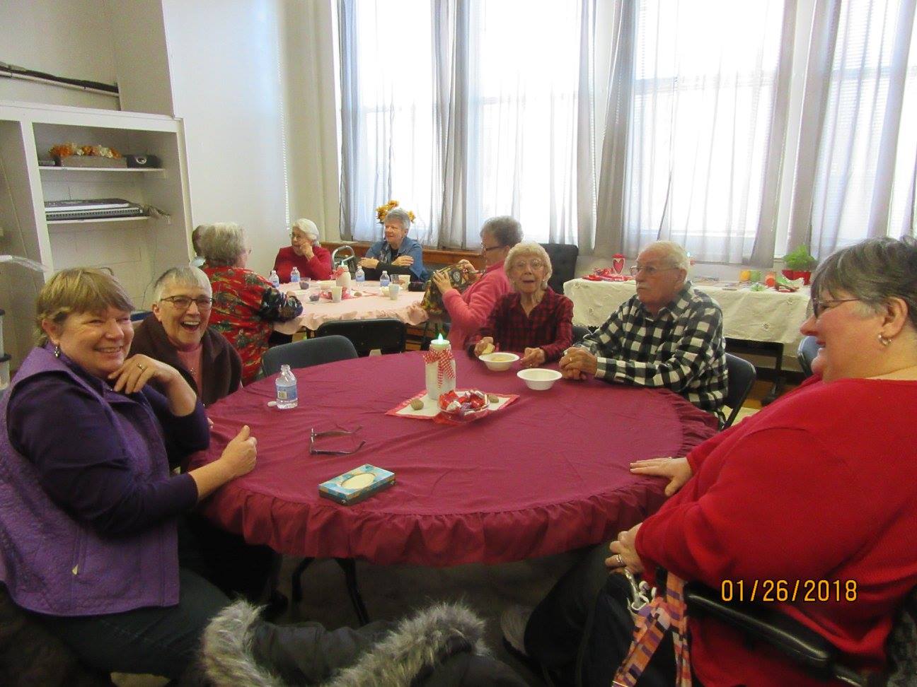 senior sit a big red table