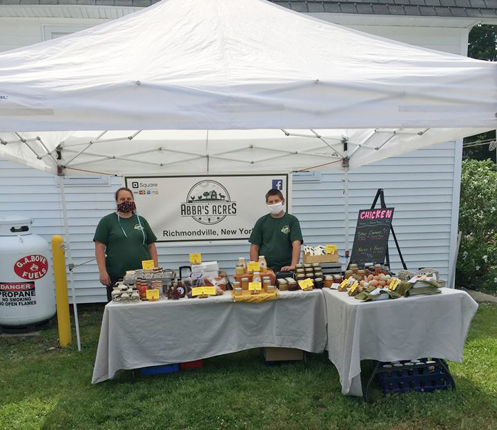 two men at a farmer's market table