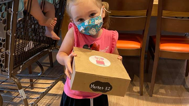 smiling girl holds a box