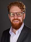 man with beard and glasses smiling