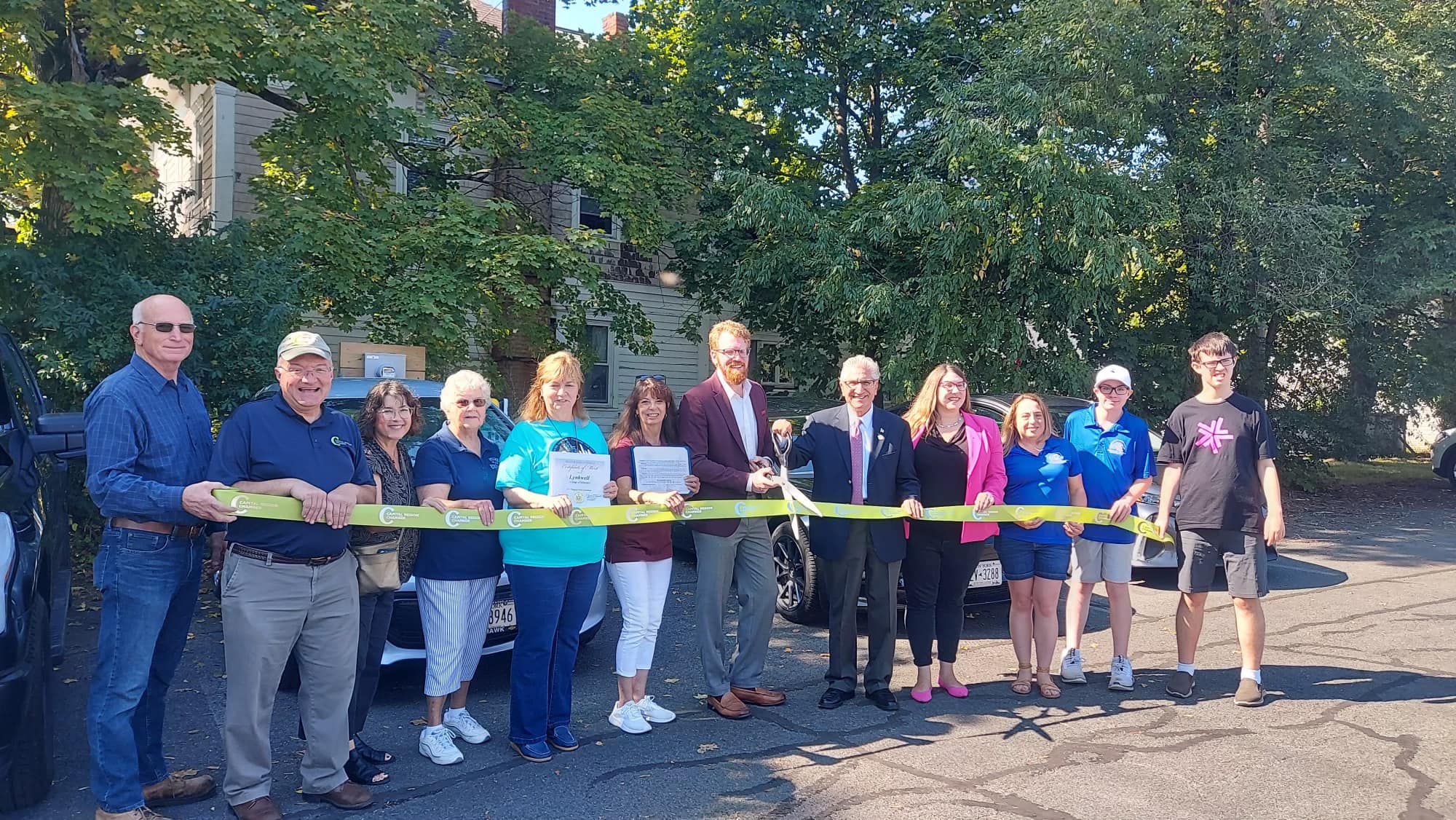 group of officials cut large ribbon